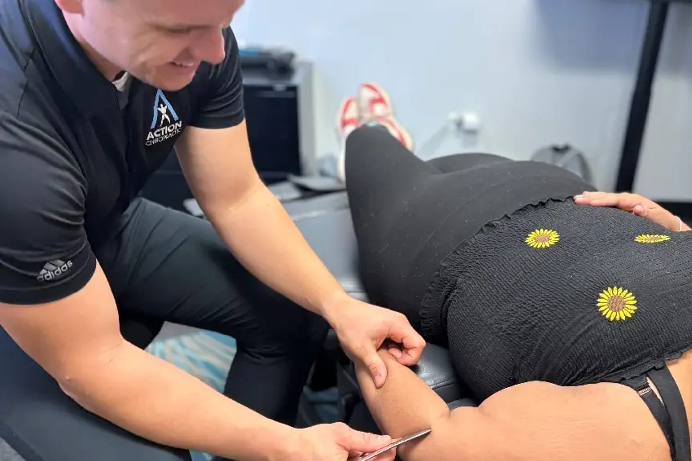 Hands-on soft tissue treatment through a patient's hip and hamstring